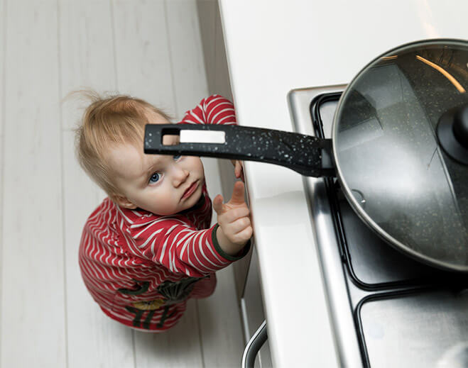 Baby reaching for hot pot